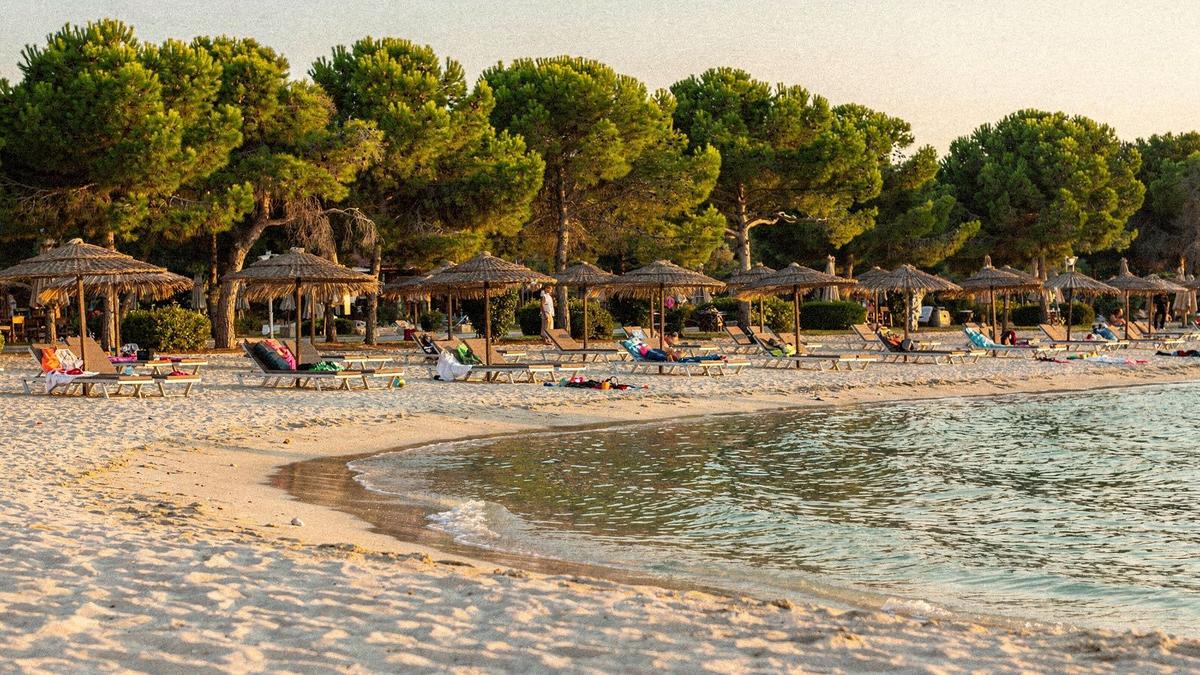 Shallow lagoon beach with sun loungers and a gentle sandy entry at a family resort in Belek